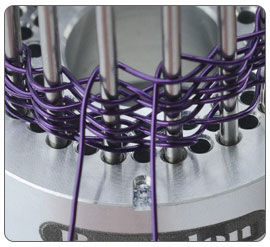 Wire being wrapped around jig pegs